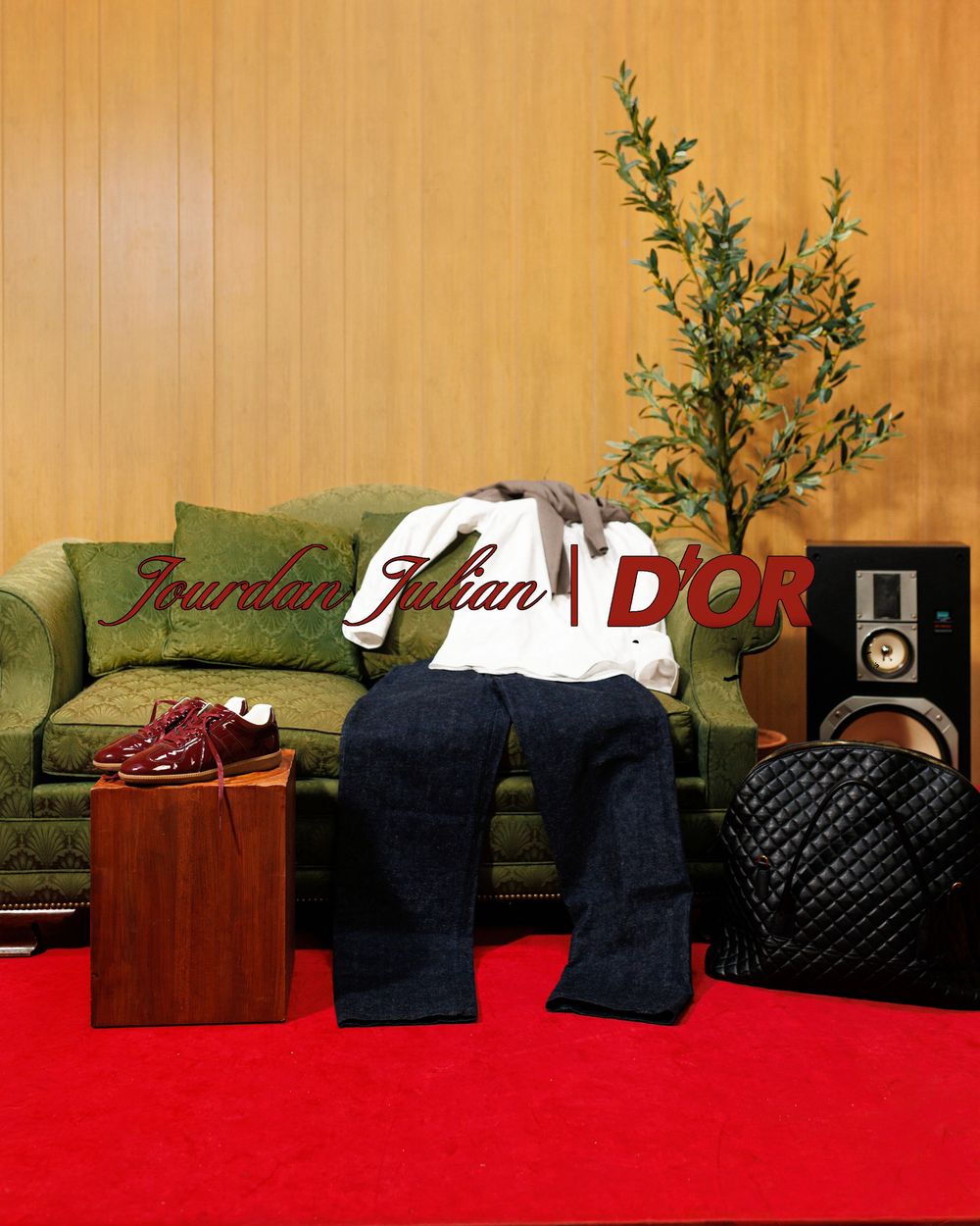 Person slouched on green sofa with Dior sneakers, speaker, and plant in Jourdan Jilian x D'OR campaign.