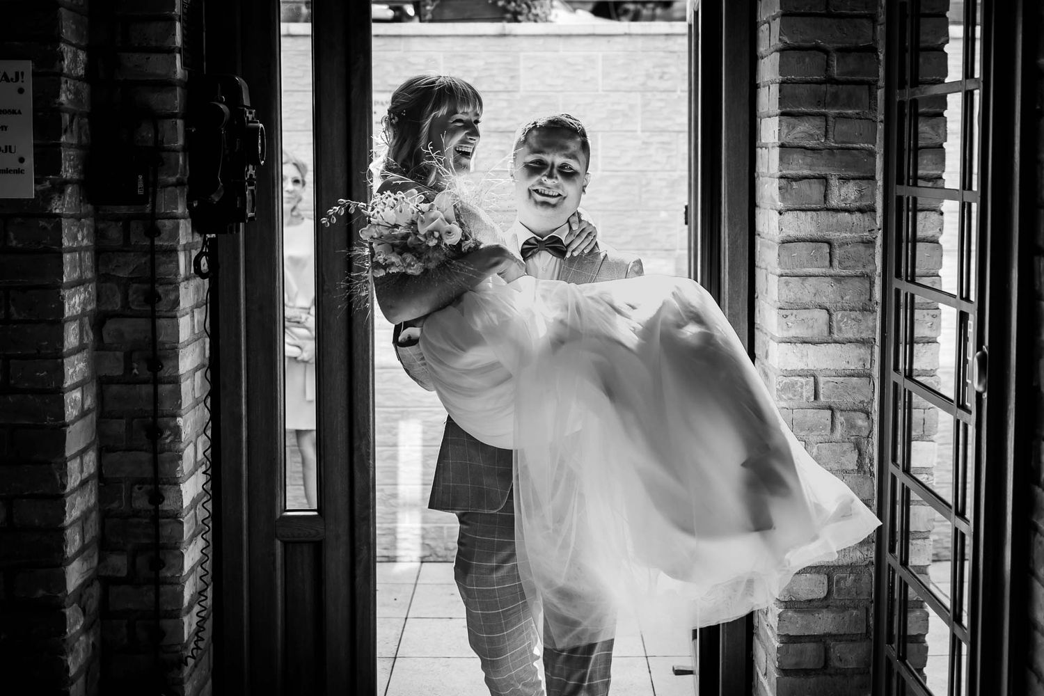 Black and white wedding portraits through architectural columns and arches.