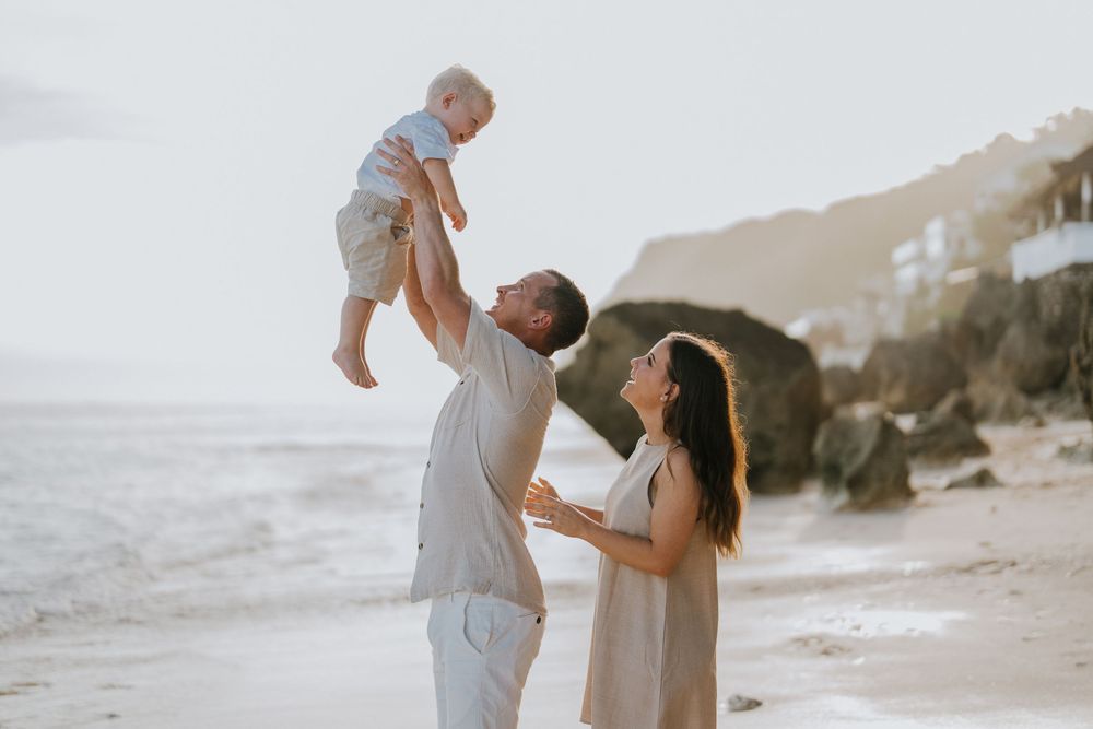 Beach family photography in Bali with an 
ocean backdrop