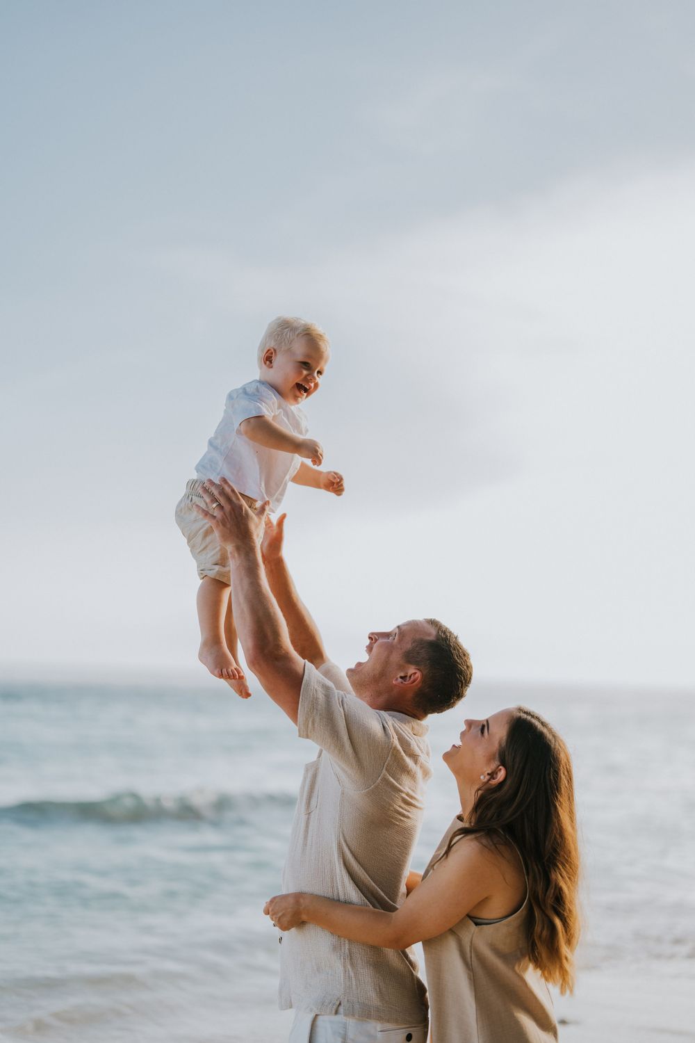 Beach family photography in Bali with an 
ocean backdrop