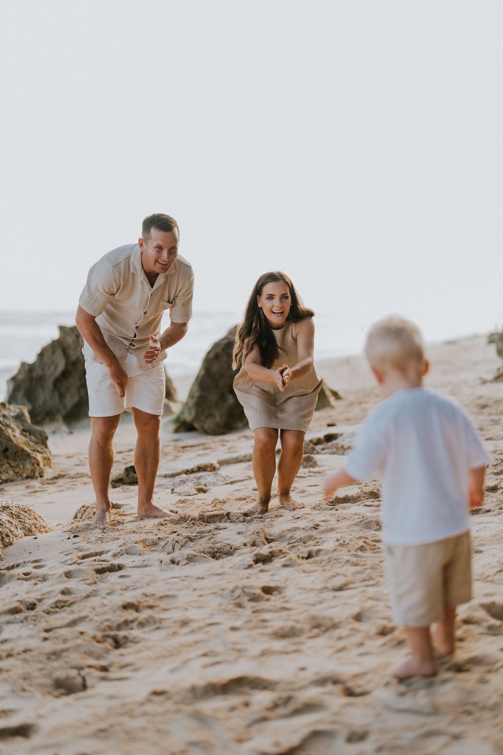 Beach family photography in Bali with an 
ocean backdrop