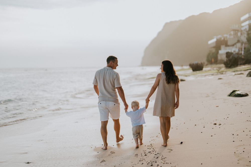 Beach family photography in Bali with an 
ocean backdrop