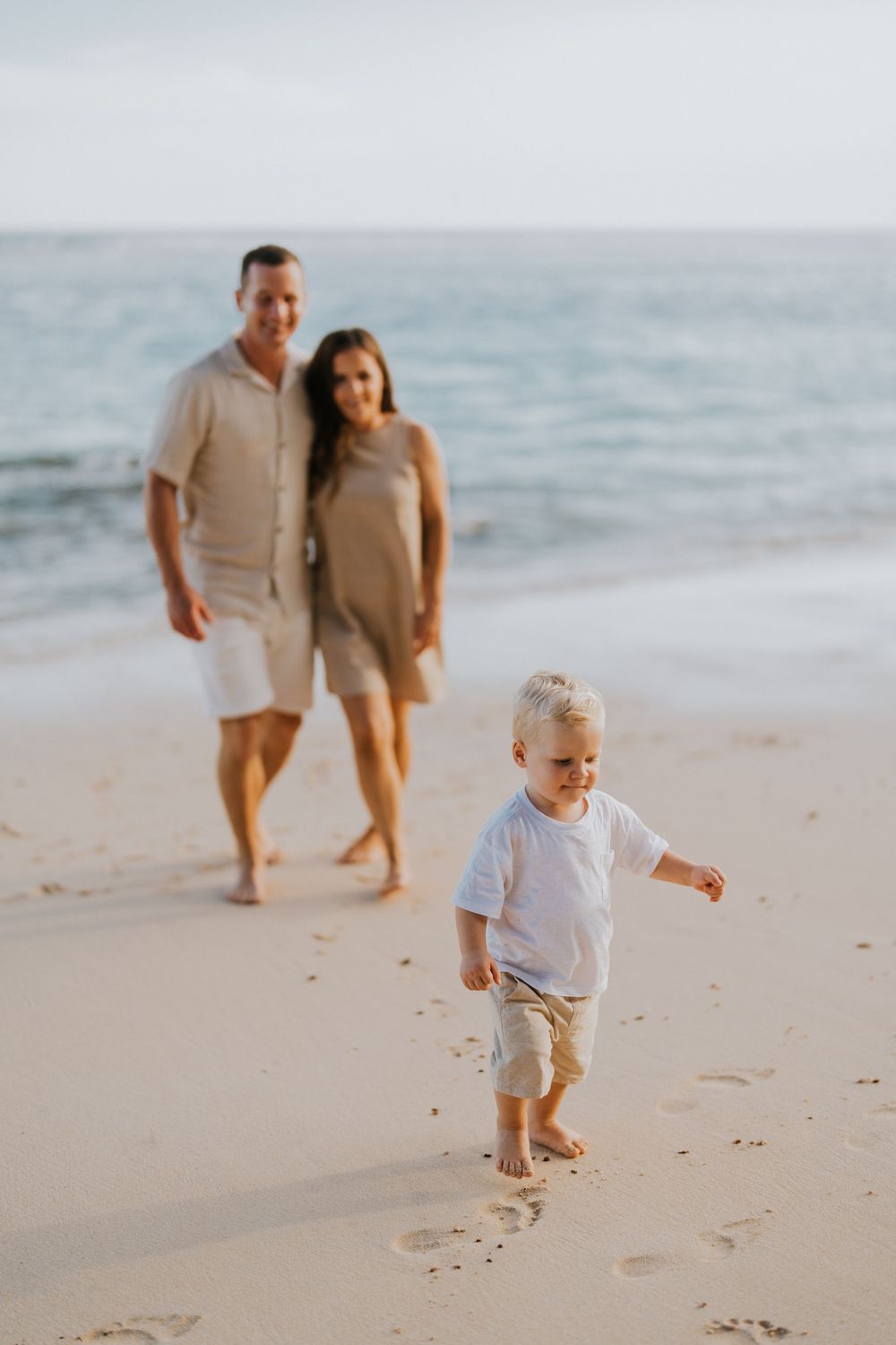 Beach family photography in Bali with an 
ocean backdrop