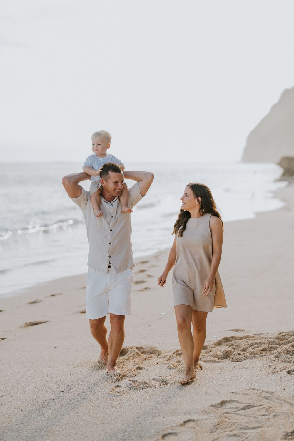 Beach family photography in Bali with an 
ocean backdrop