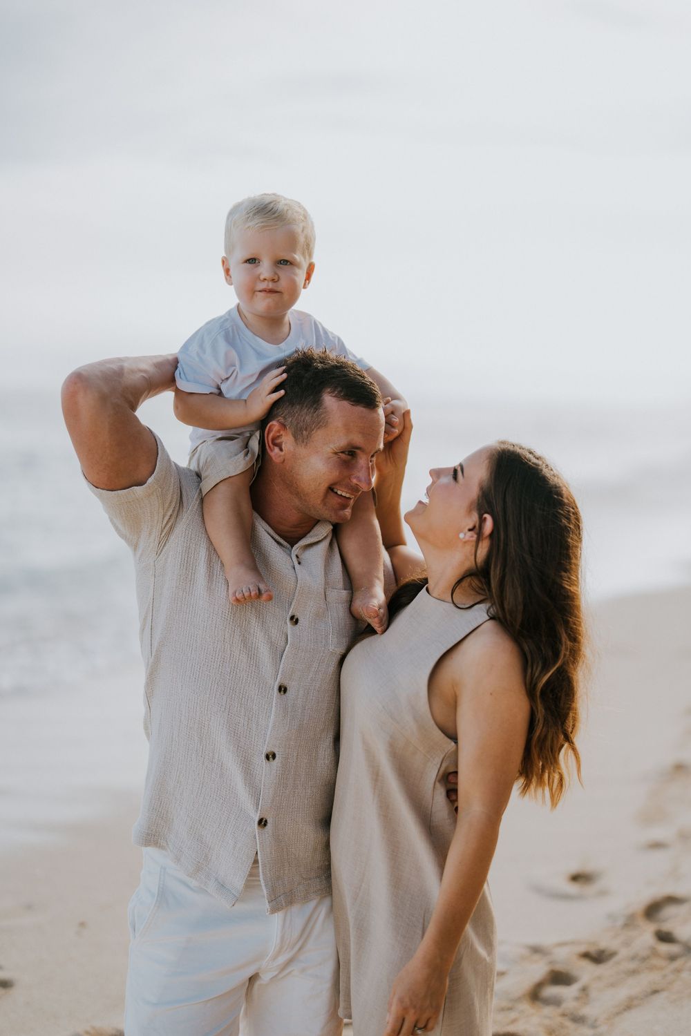 Beach family photography in Bali with an 
ocean backdrop