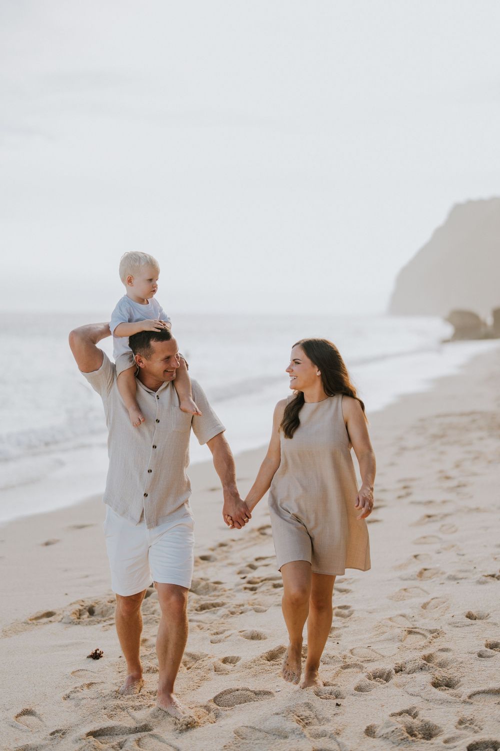 Beach family photography in Bali with an 
ocean backdrop