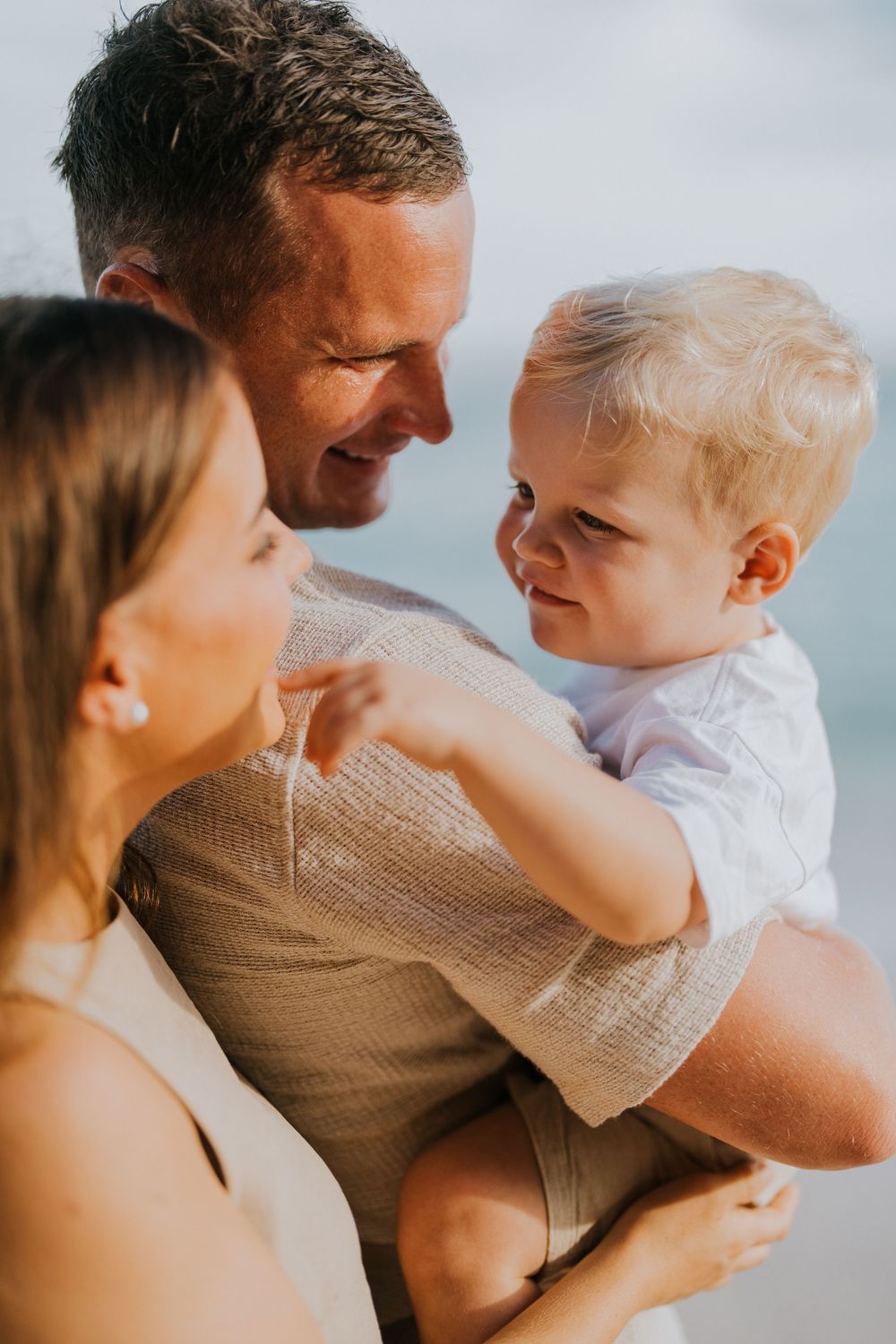 Beach family photography in Bali with an 
ocean backdrop