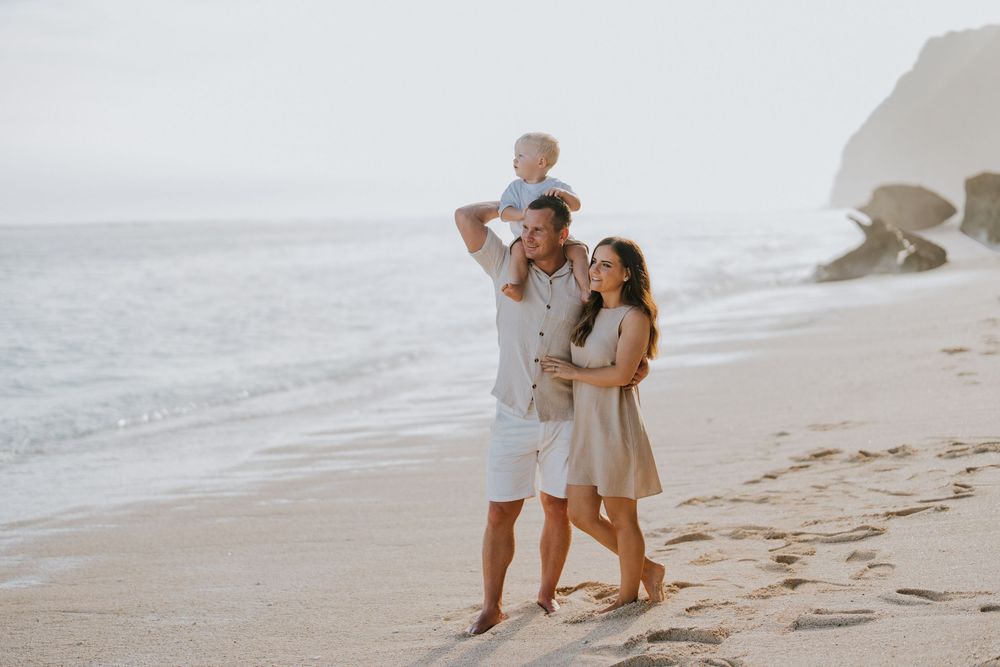 Beach family photography in Bali with an 
ocean backdrop