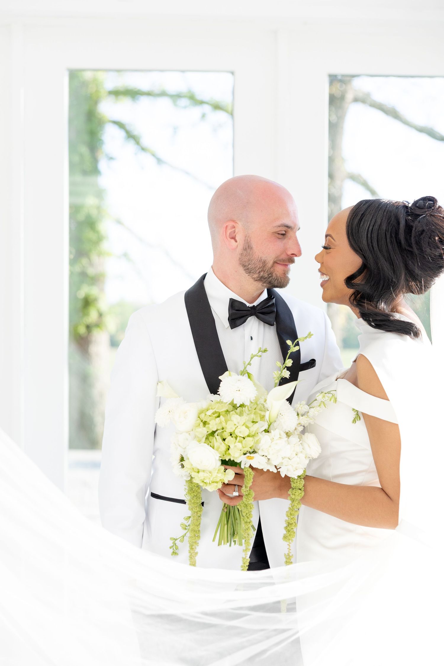 Light and airy wedding photos at The Glass House near Huntsville, Alabama capturing joyful, timeless moments of a bride and groom