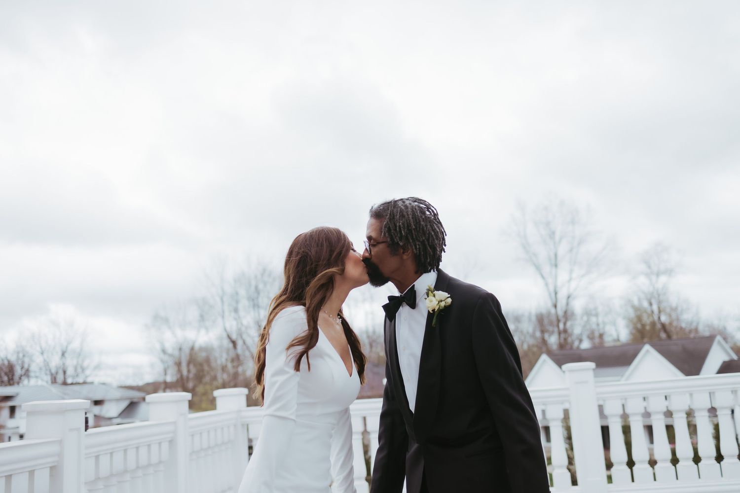 Bride and groom, wedding portrait kissing on a windy day at Holliday Farms in Zionsville, Indiana
