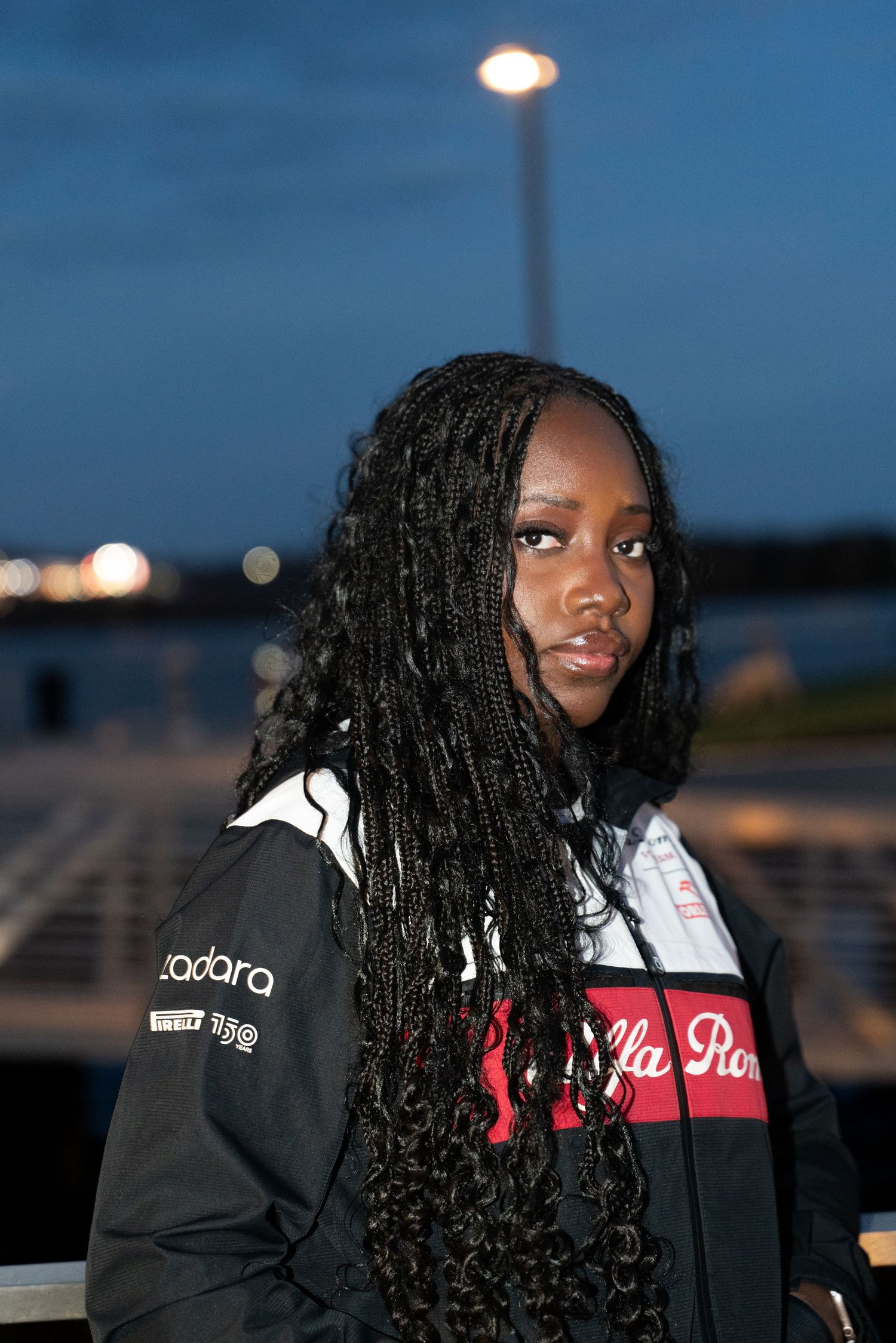 Nighttime portrait with street lights and urban background.