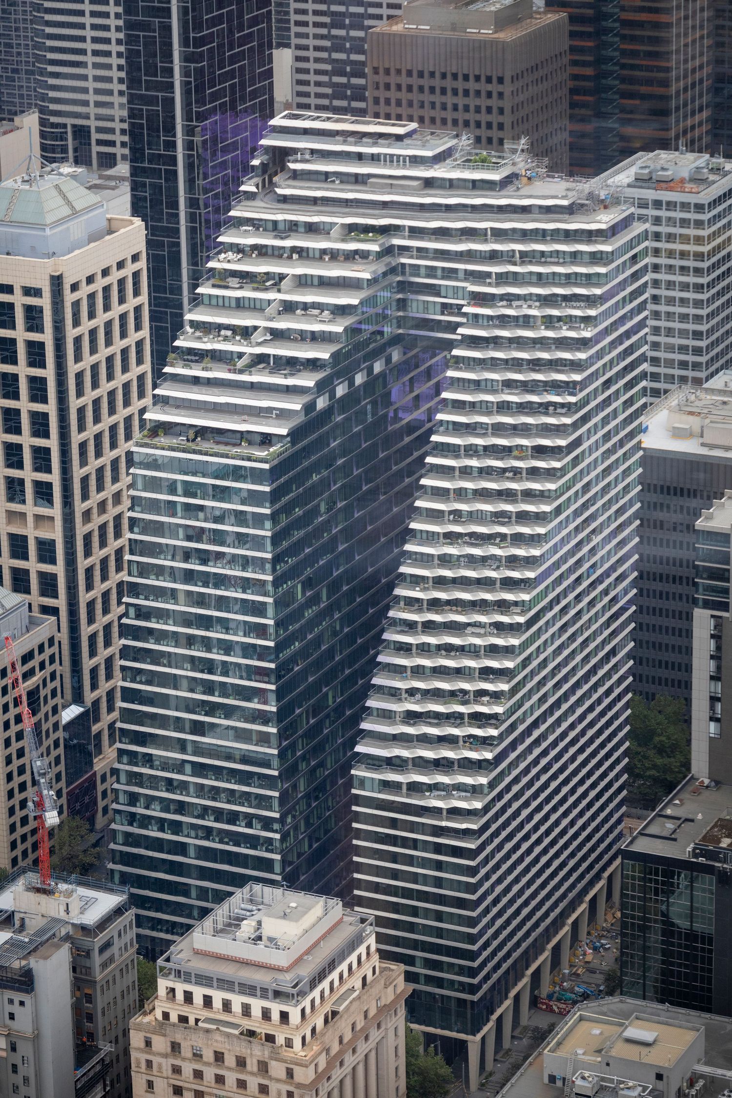 Dramatic stepped architecture of a skyscraper with layered balconies in the CBD.
