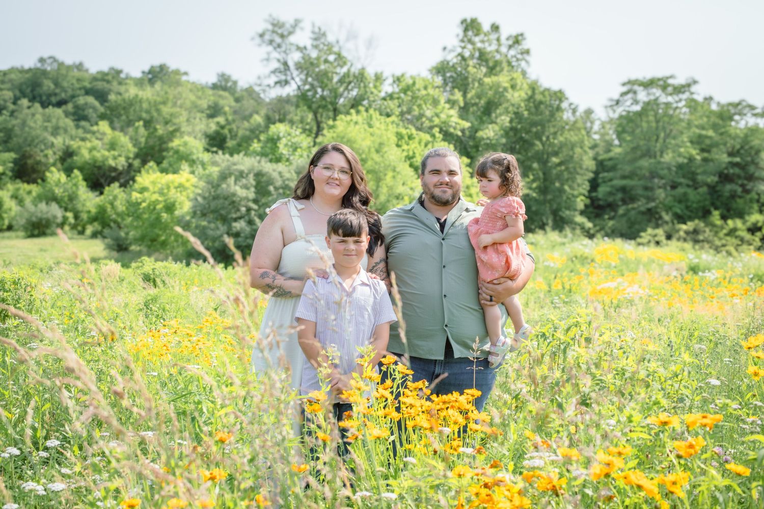 Blended family portrait in wildflower field in Cincinnati capturing high-end, elegant outdoor family photography for premium clients
