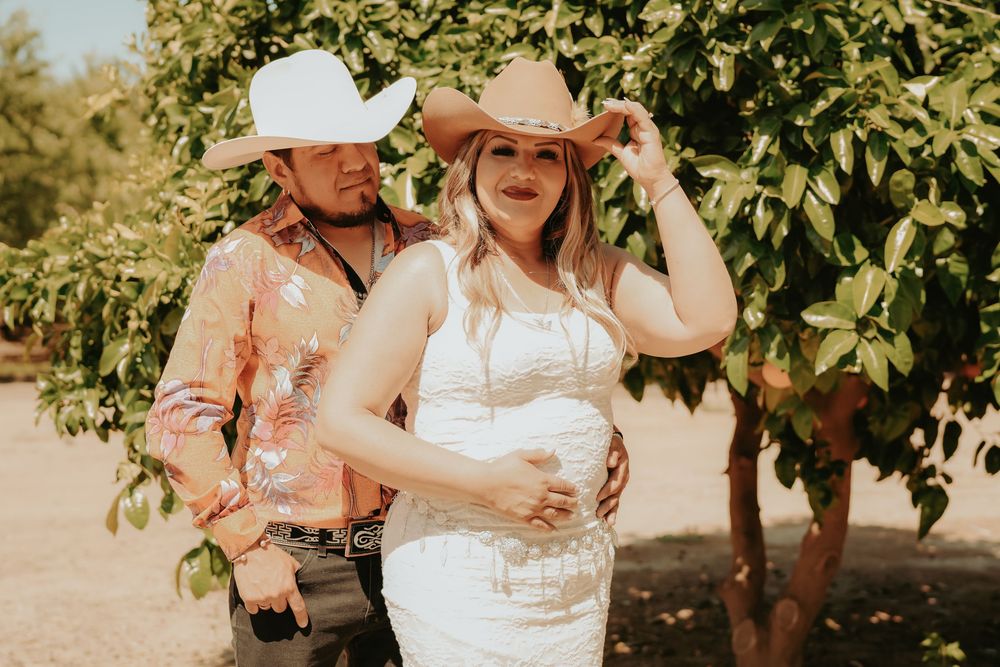 Rustic outdoor wedding photos captured in a golden sunlit grove with soft sepia tones and natural greenery.