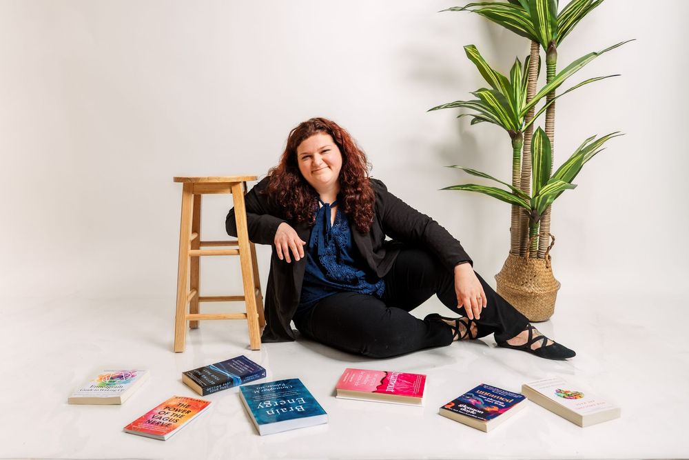Lifestyle product photography setup with books and decorative plants against white background.