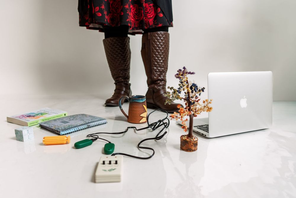 Lifestyle product photography featuring books and office accessories on white surface.