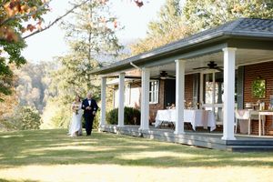 Scenic mountain view of wedding reception setup on covered porch.