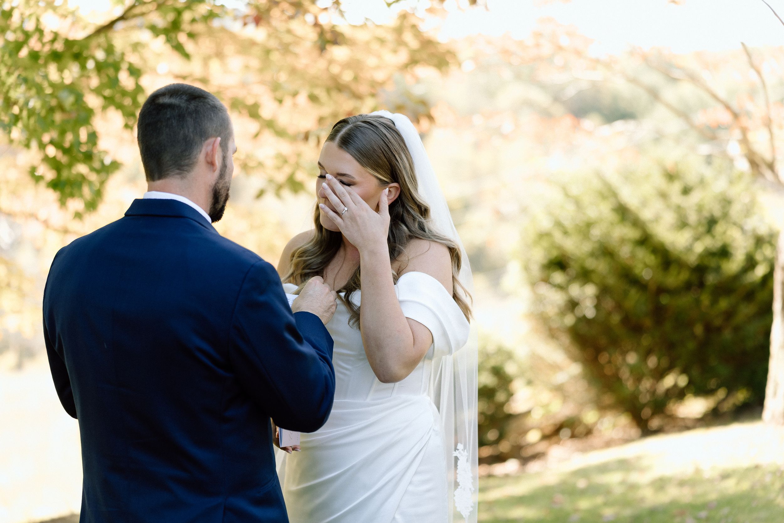 A romantic outdoor first look moment between a couple during their wedding ceremony.