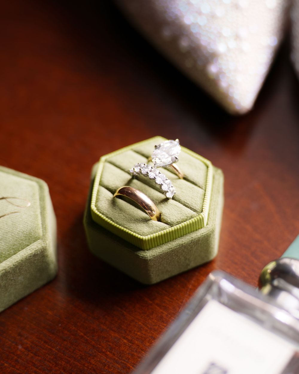 Atmospheric macro shot of a green keycap with a ring-like symbol, sitting at an angle on a dark wooden surface.