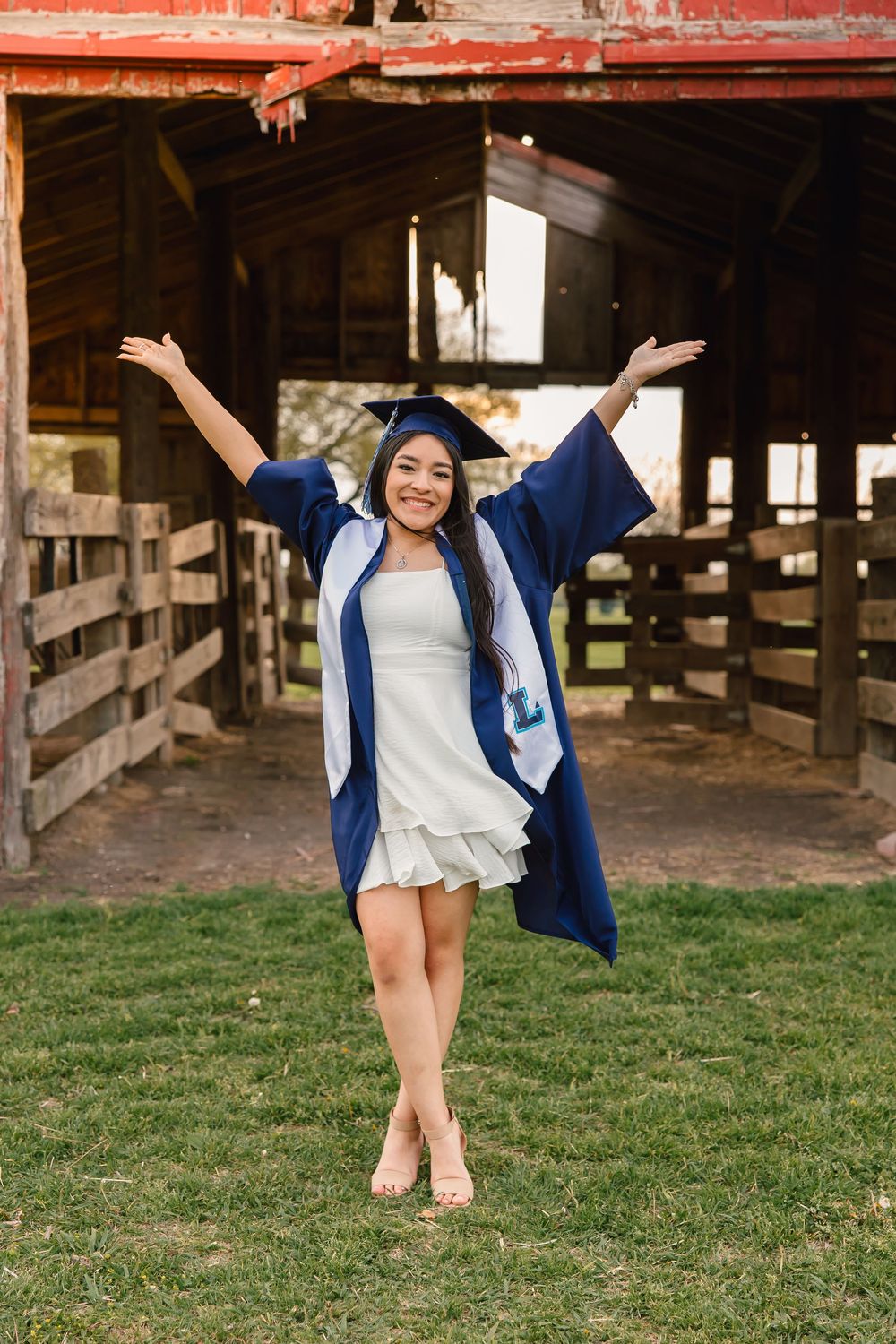A sequence showing a graduate throwing their arms up in celebration on grass outside a rustic barn structure.