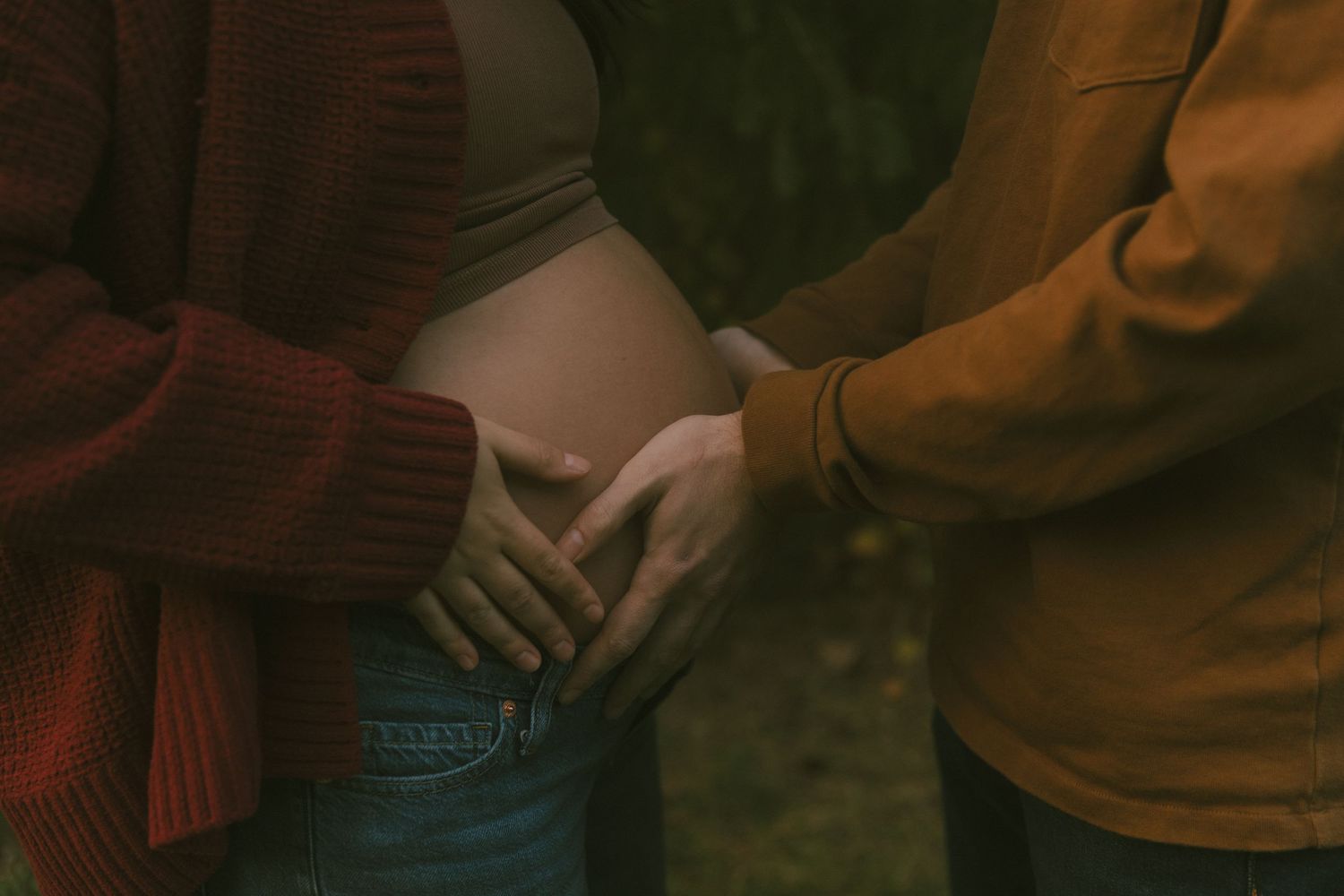 Close-up maternity photo taken by Richelle Healy Photo at a park in Michigan.