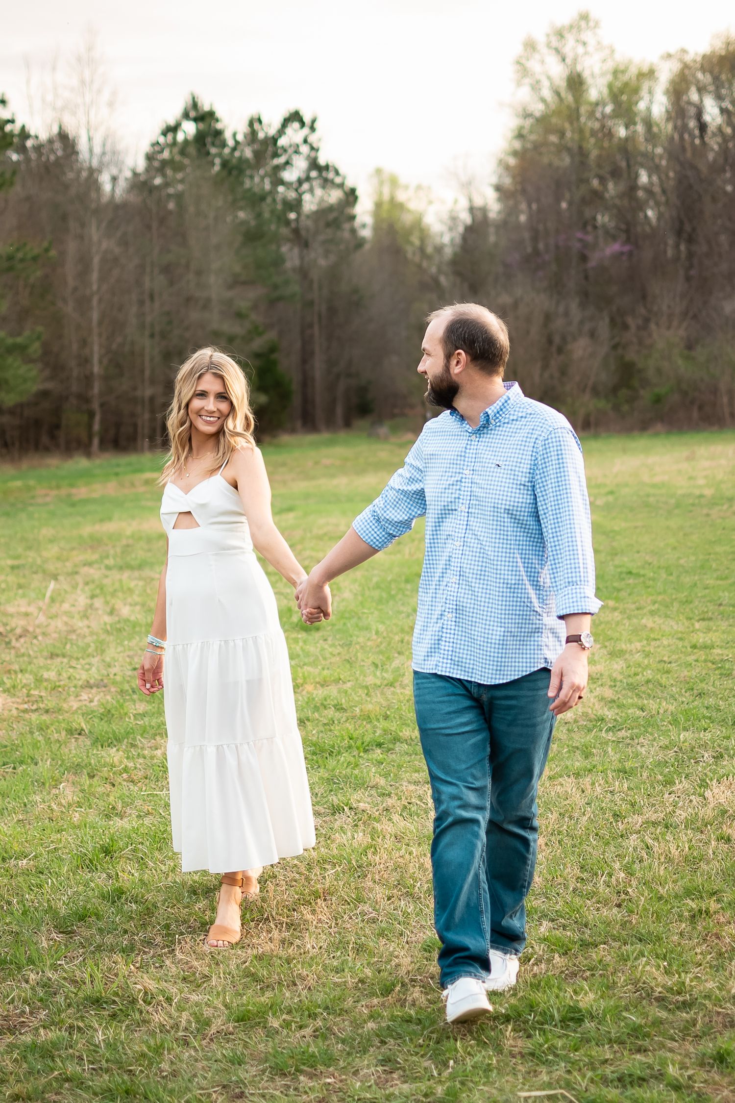 couple posed in a field for a couples photo session
