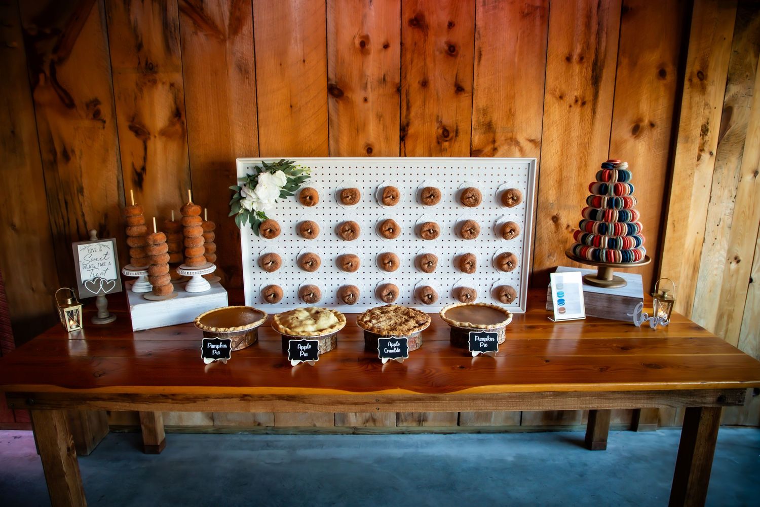 Rustic wooden table display with organized grid of wedding favors and decorative elements.