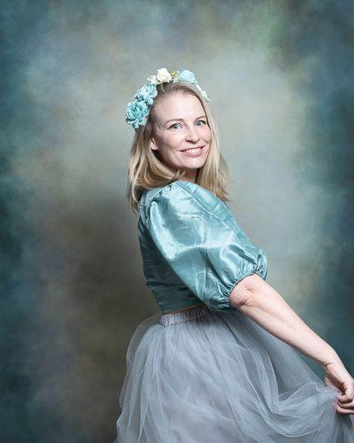 selfportrait in dreamy teal and gray tones featuring a tulle skirt, teal blouse and floral hair accessories.