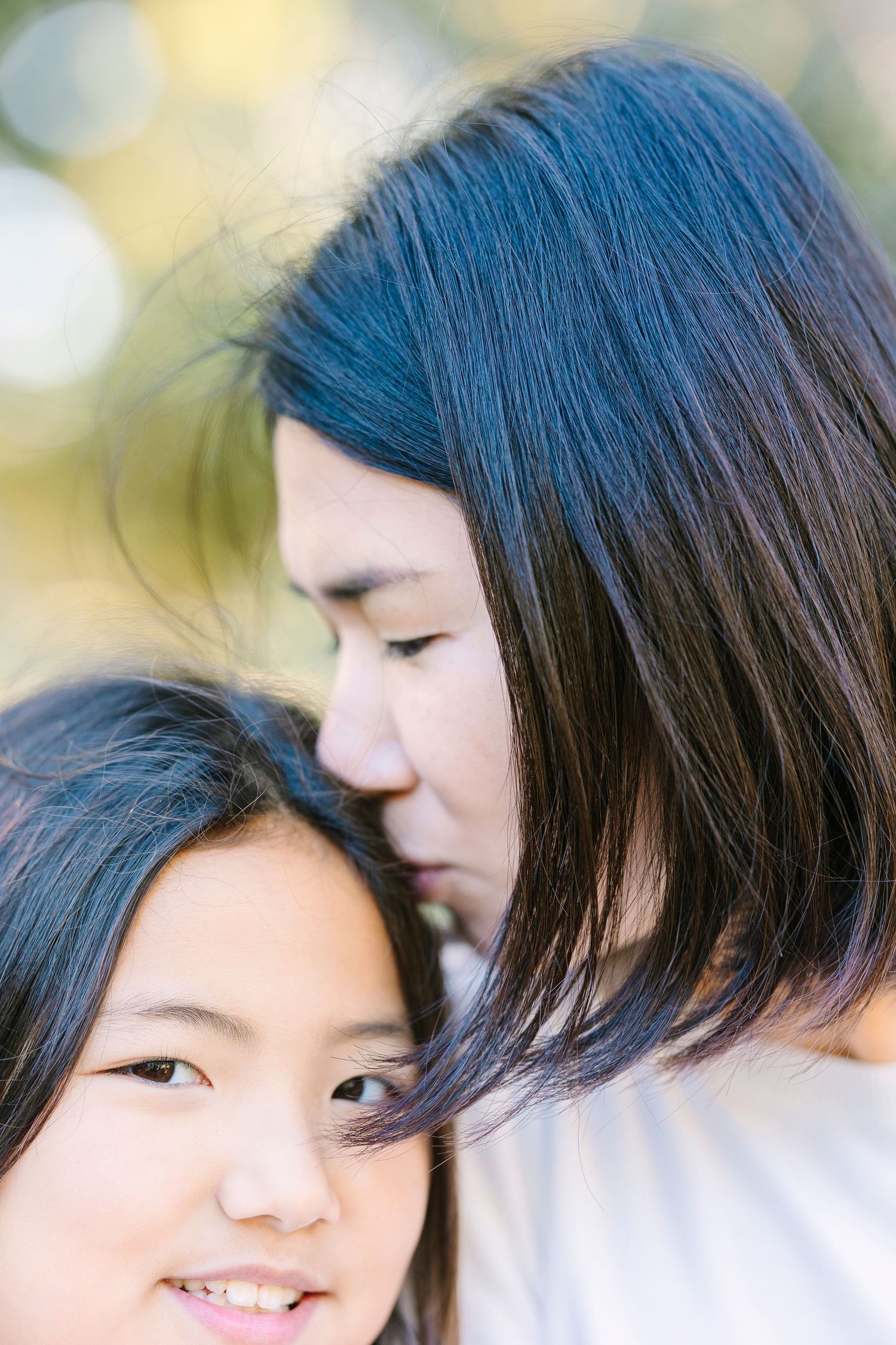 A tender close-up portrait showing affection against a soft bokeh background.
