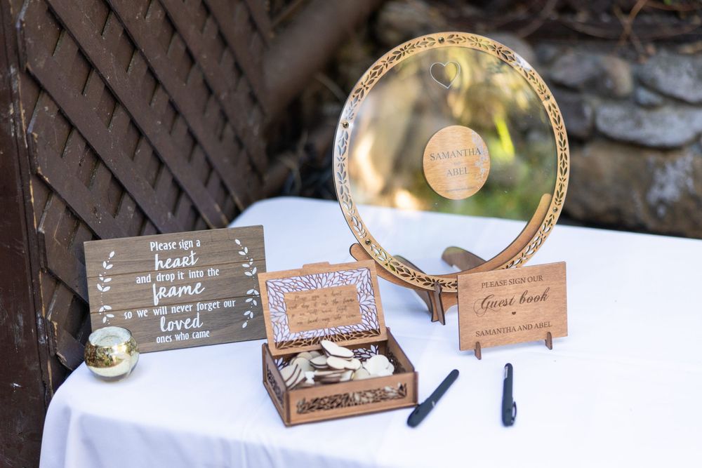 Gold and white floral place cards with elegant calligraphy lettering displayed at a wedding reception table.