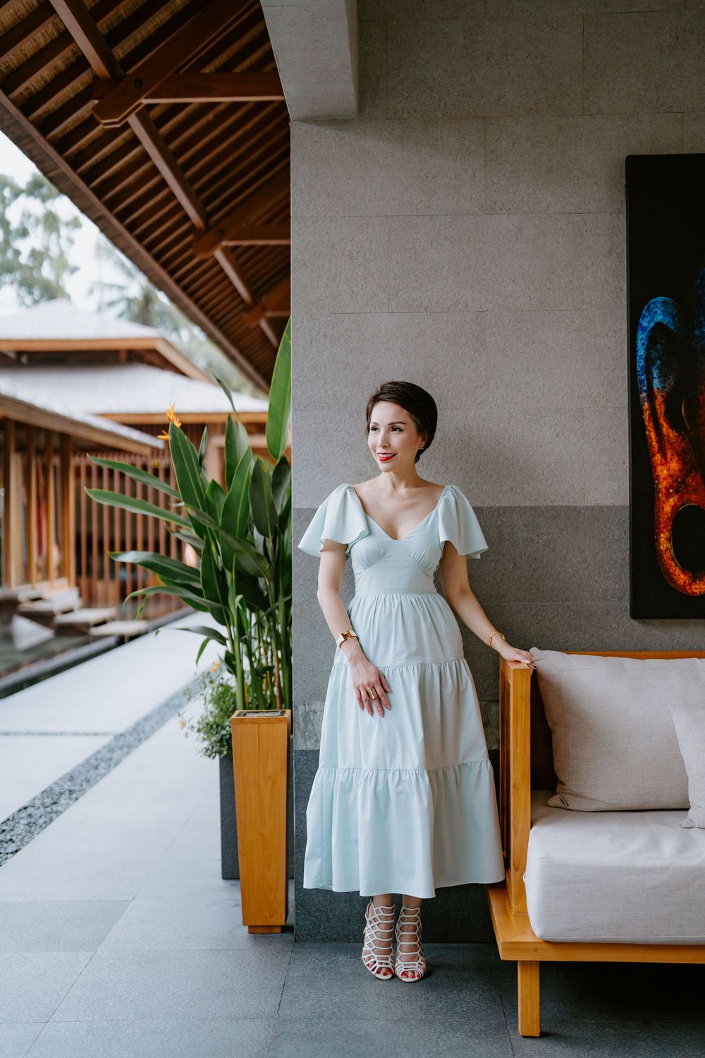 Fashion photography in a modern tropical villa with wooden beams and white walls.