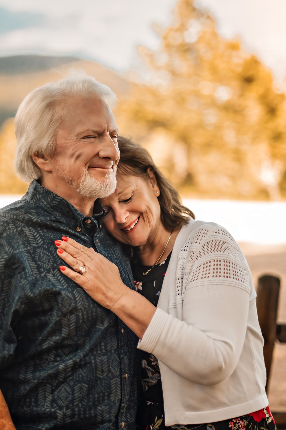 a wife resting into her husbands chest as they celebrate their 50th anniversary in Estes Park, CO