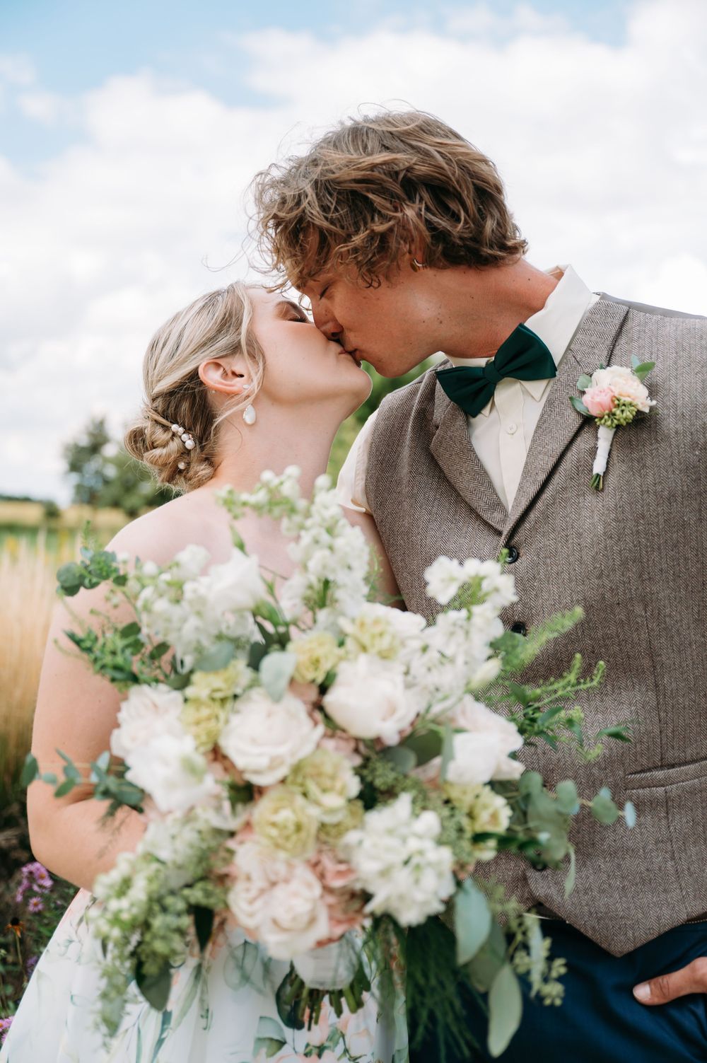 low angle of bride & groom kissing at lowe park marion iowa taken by cedar rapids midwest wedding photographer