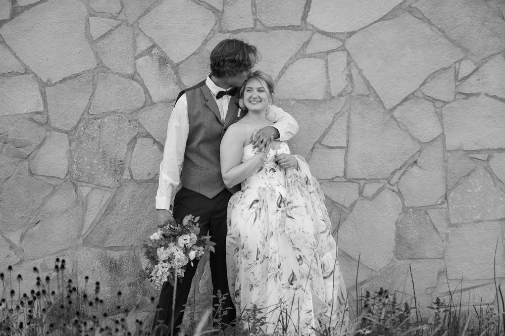 groom kissing bride outside of lowe park marion iowa taken by cedar rapids midwest wedding photographer