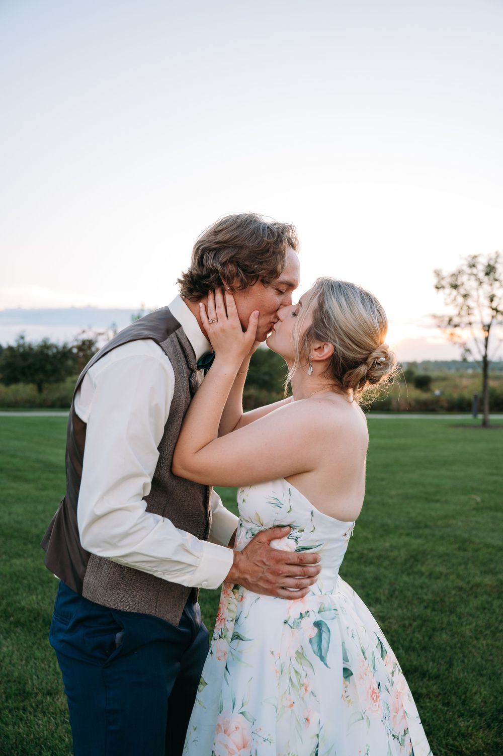 Groom & bride kissing during gold hour at Lowe Park Marion Iowa taken by cedar rapids midwest wedding photographer