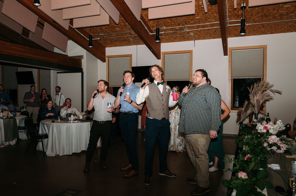 flash photo groom and 3 friends singing karaoke during reception at Lowe Park in Marion Iowa by midwest wedding photographer Elisa Tonne