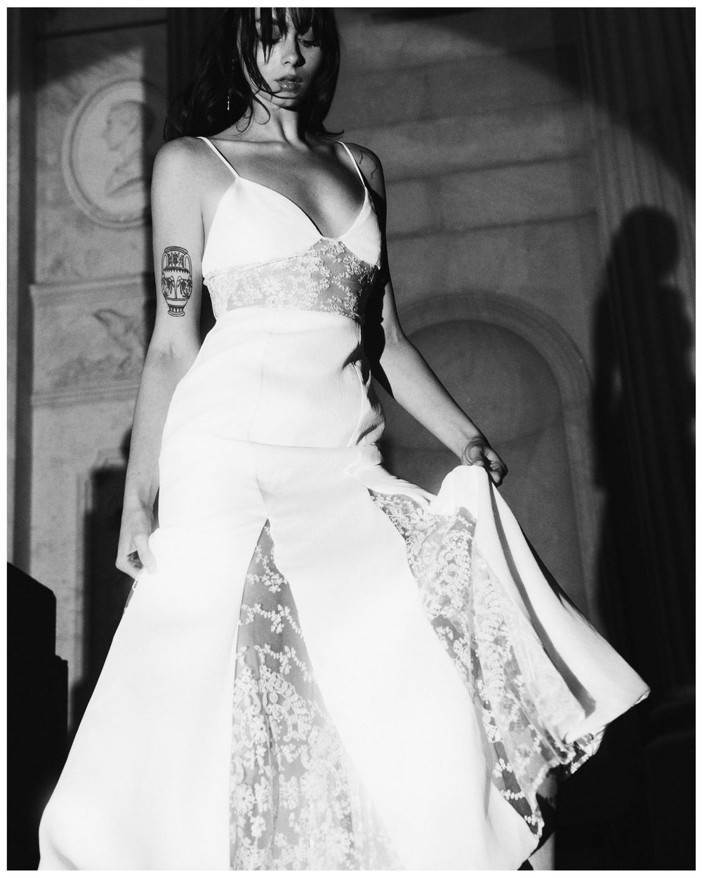 A black and white fashion photo series showing a model in an elegant white dress with delicate lace details.