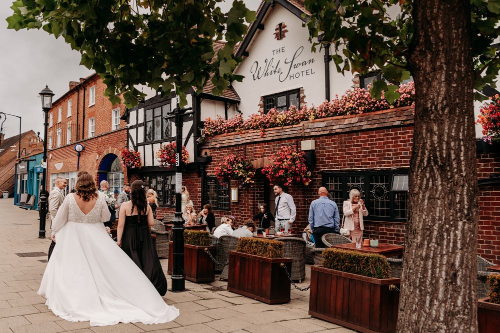 Wedding venue outdoor courtyard decorated with string lights and brick walls creating a romantic ambiance.