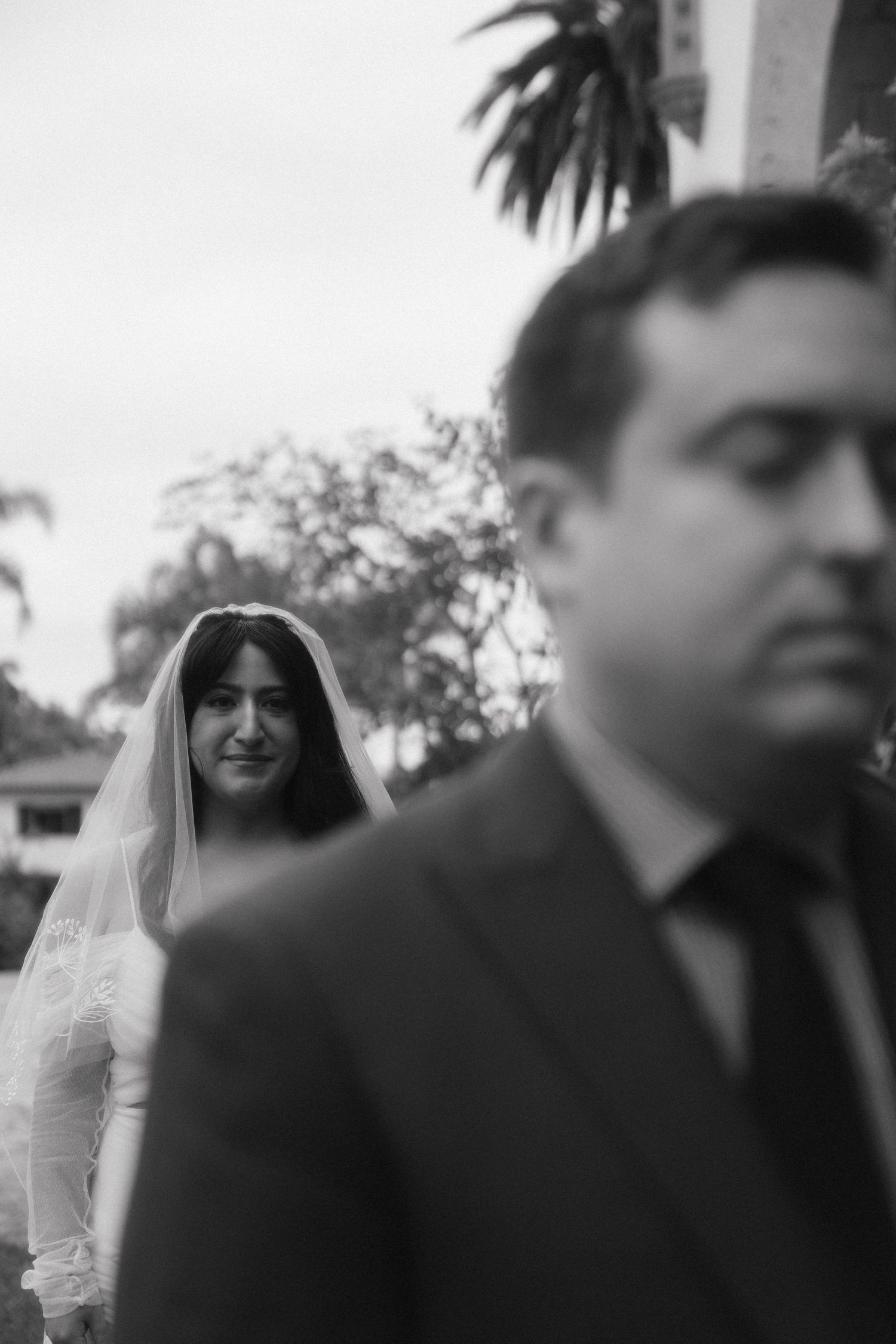 A black and white photo sequence shows a bride in a veil with guests in dark suits at an outdoor wedding ceremony.
