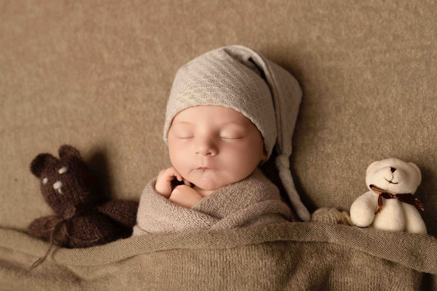 Adorable newborn baby photos arranged in a filmstrip style showing sleeping poses with soft brown teddy bear accessories.