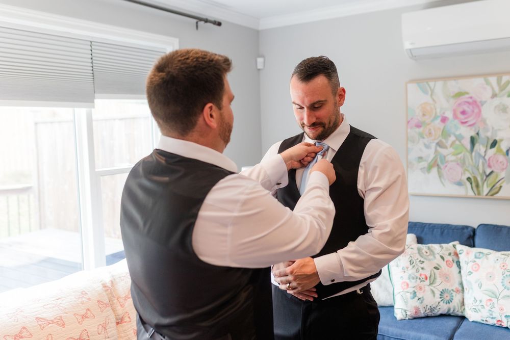Sequence of photos showing formal attire being adjusted and straightened during a special occasion preparation.