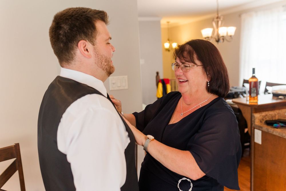 Candid moments of laughter and joy during wedding preparations in a brightly lit room.