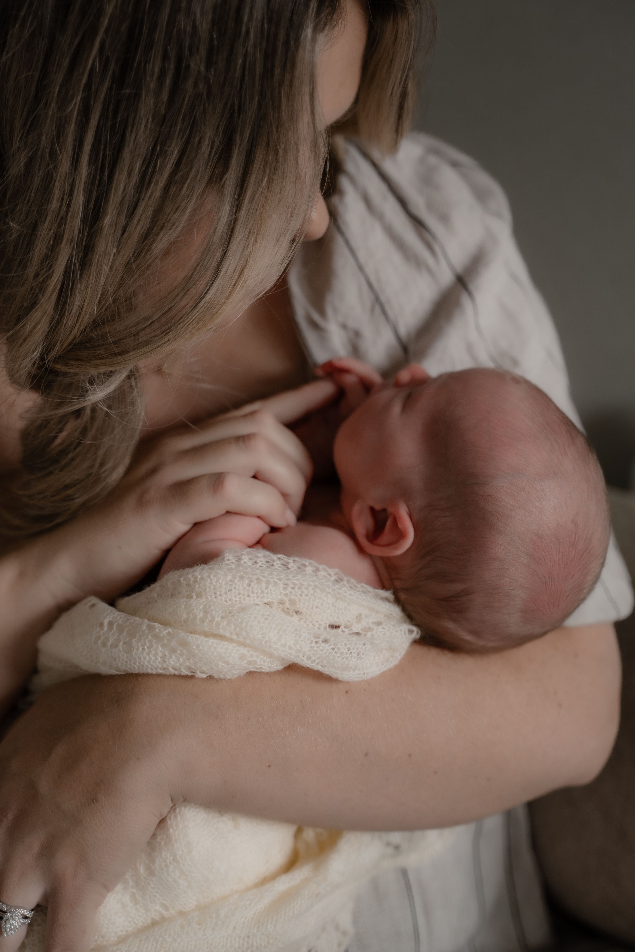 A tender moment of breastfeeding captured in a series of intimate photographs showing mother and baby bonding.