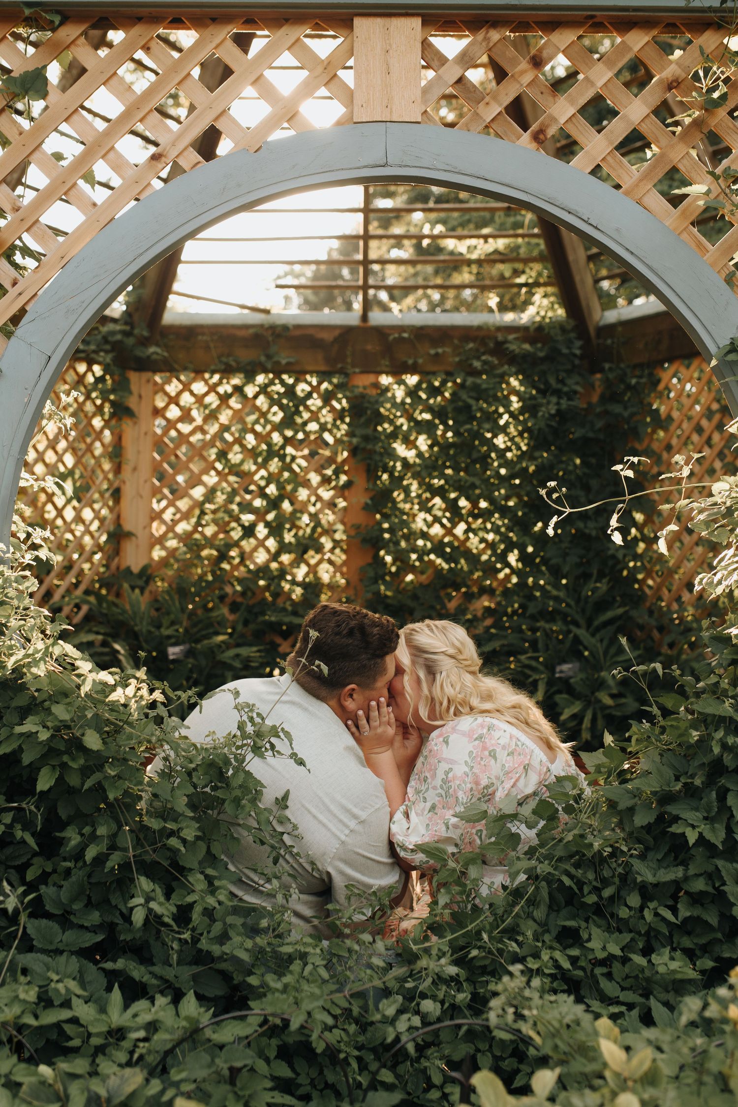 Couple sharing a kiss at Columbus, Ohio metro park on a golden summer evening.