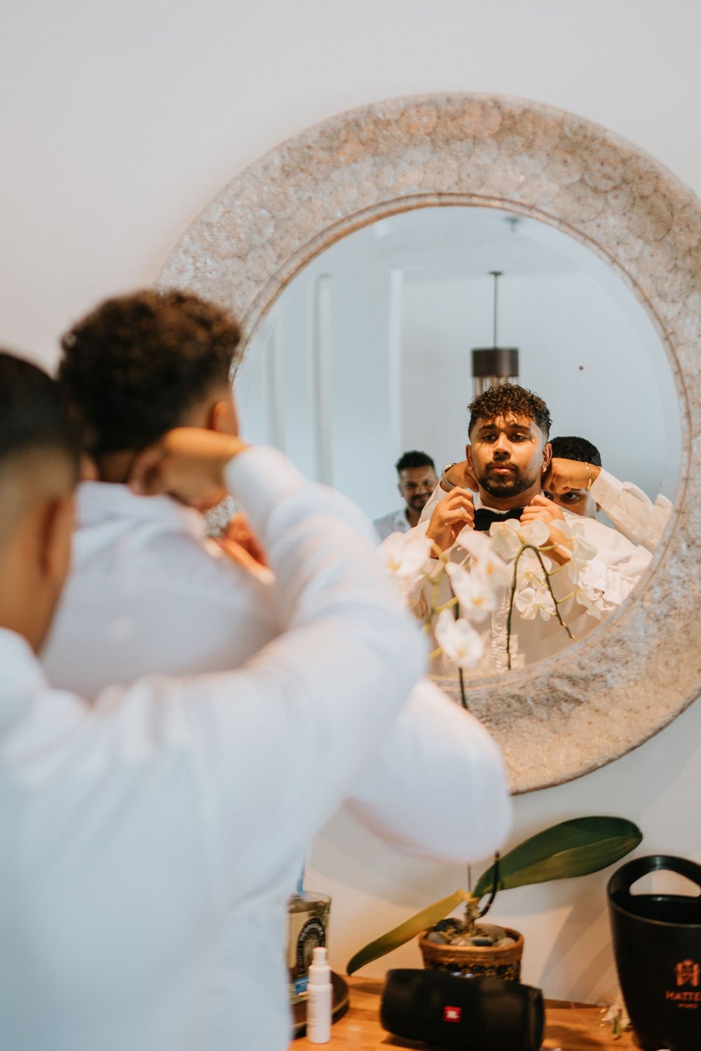 Getting ready scene reflected in an ornate vintage mirror.