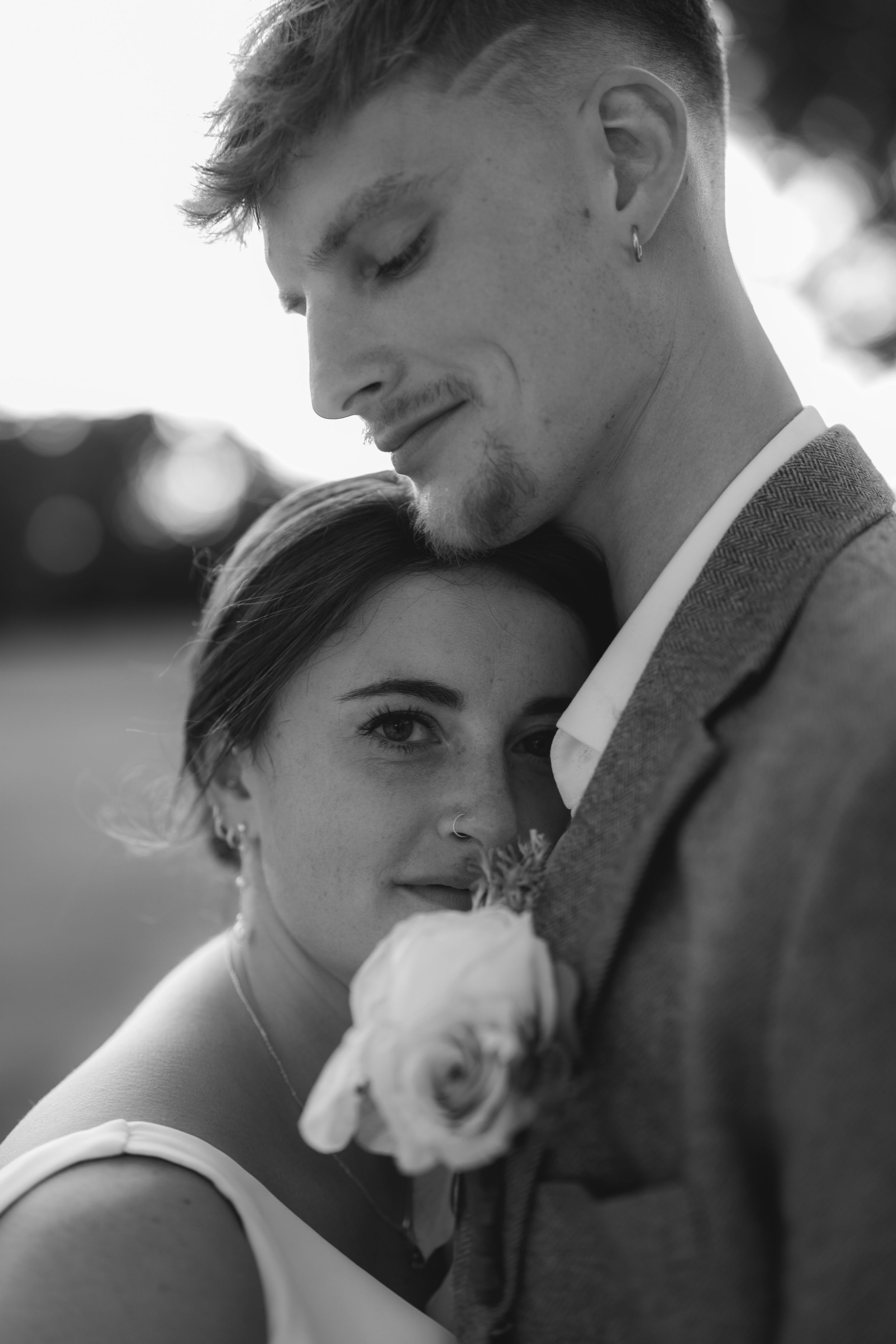 A romantic black and white photo series showing sweet tender moments between a couple in wedding attire.
