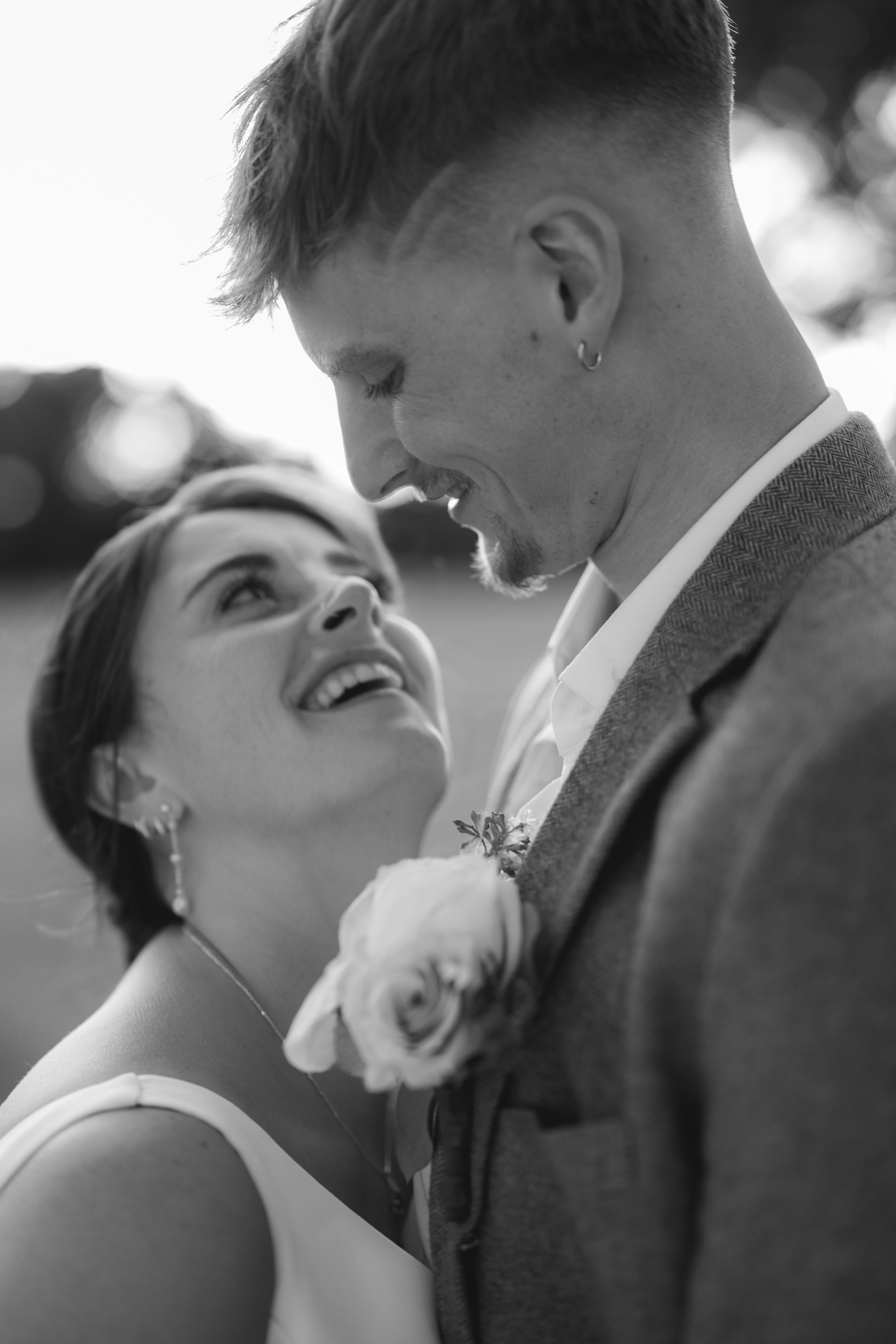 A romantic black and white photo series showing tender moments between a couple sharing laughter and embraces.