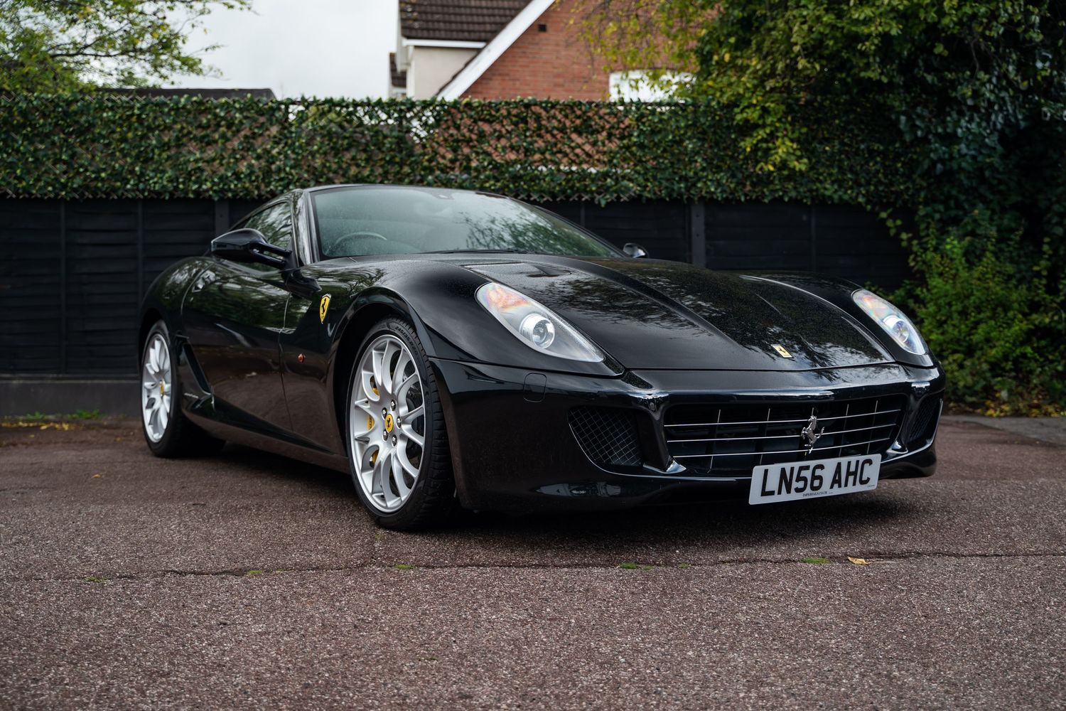 Three-quarter front view of black Ferrari 599 GTB showcasing sleek aerodynamic design.