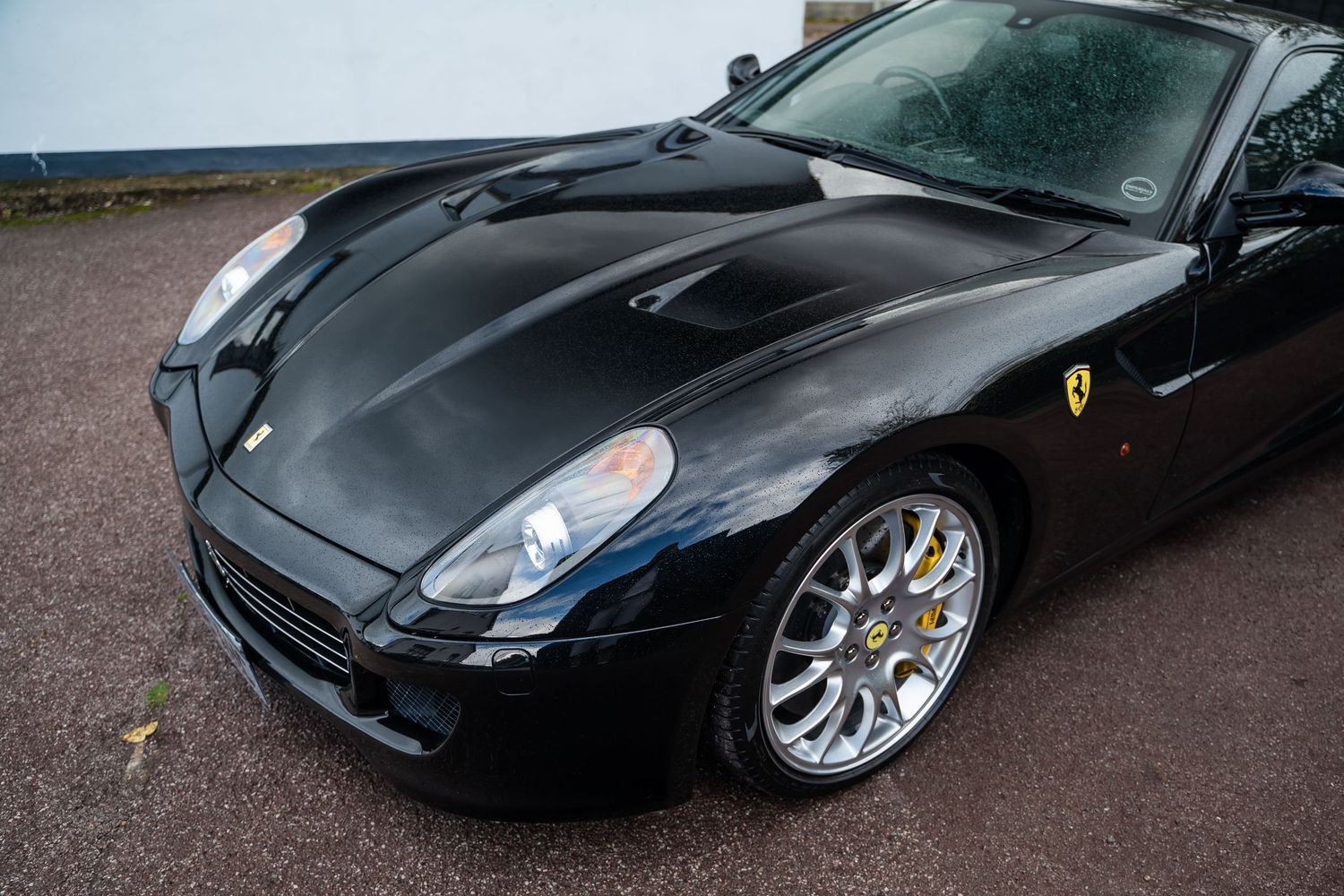 Close-up detail shots of black Ferrari's exterior panels and curves.