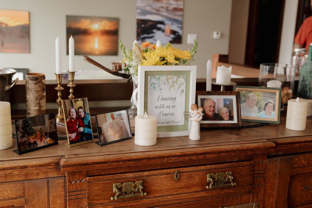 Rustic wooden bar counter with vintage decor and framed photos displayed on shelves.